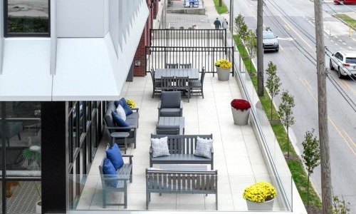 resident balcony with tables, chairs and neighborhood views