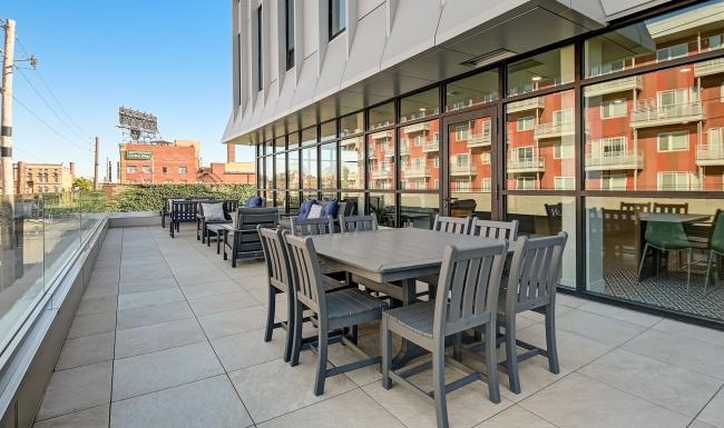 spacious balcony with tables and chairs